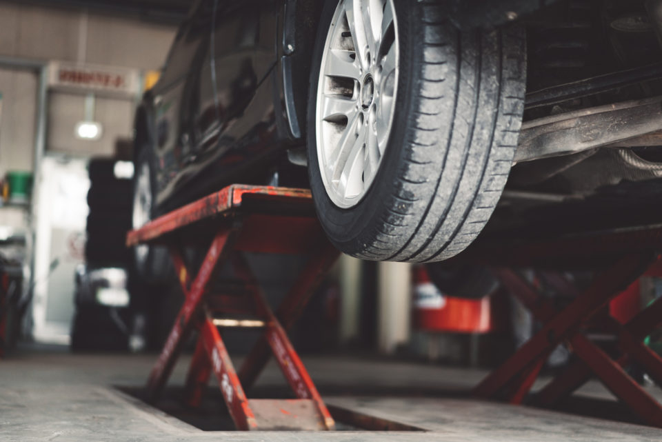 Car lifted in a service center.