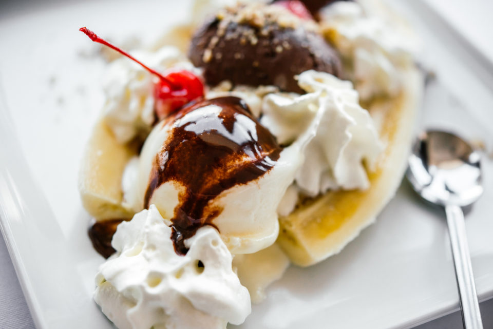 Banana split ice cream served on white plate