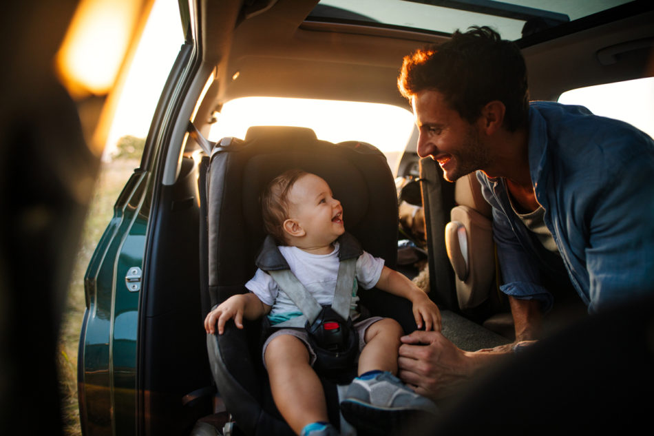 Baby being secured in a car seat