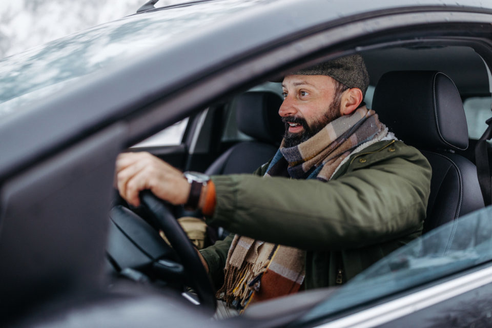 Mature man traveling by car during the winter