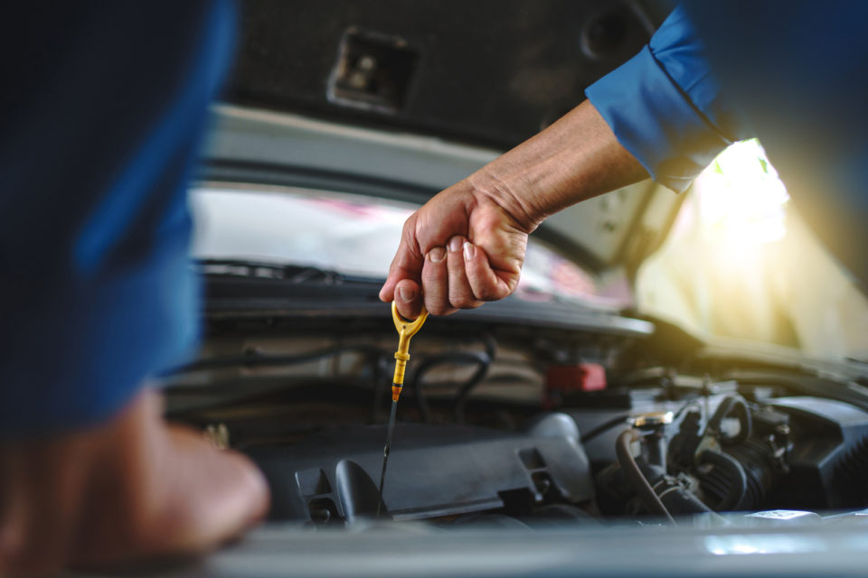 auto mechanic performing an oil change