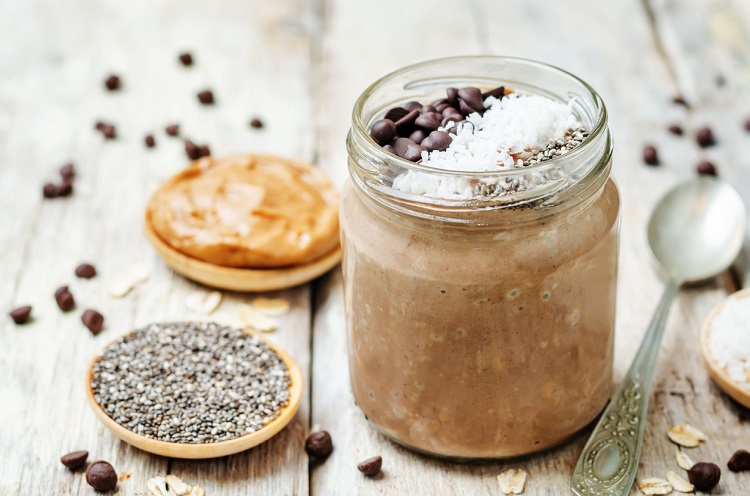 Chocolate Coconut Chia seeds overnight oats on a white wooden background