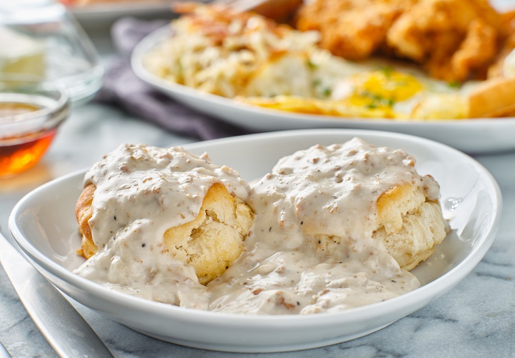 biscuits and gravy with sausage on plate close up