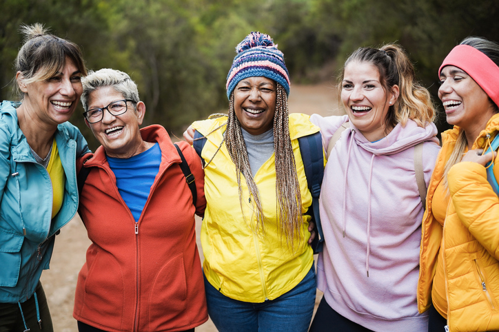 Multiracial women having fun during trekking day in to the wood - Escape to nature and travel concept