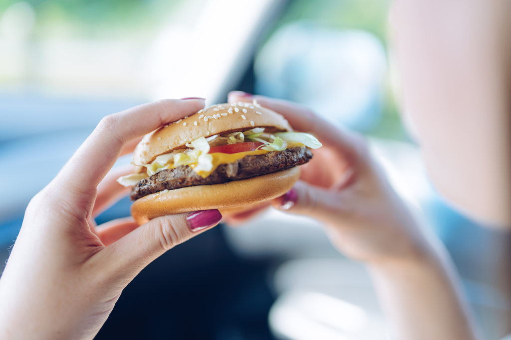 girl holding a cheeseburger